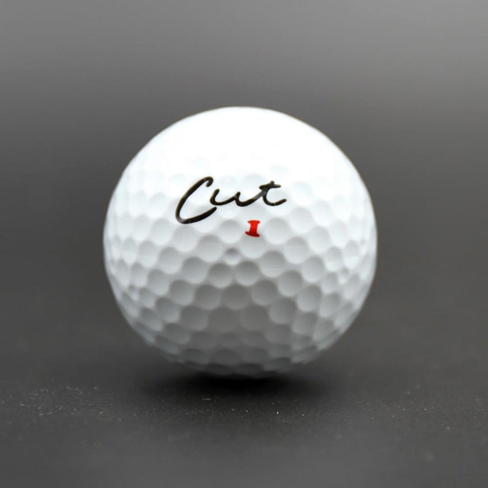 Cut DC Dual Core 4 Piece Golf Ball Solo With a Dark Background