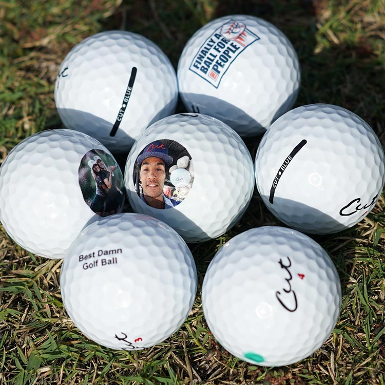 Group of Seven Custom Logo, Text, and Image Golf Balls on Grass