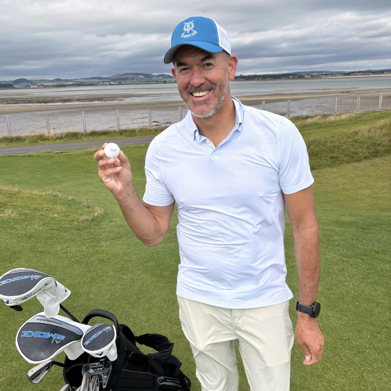 Golfer Holding a Cut Red 2 Piece Golf Ball at St Andrews Golf Course